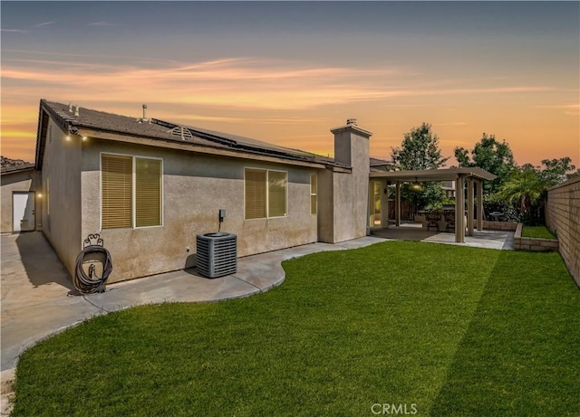 31139 Little Camille Way, Menifee, CA 92584 - rear view of house with solar panels, a patio, a chimney, stucco siding, and a fenced backyard