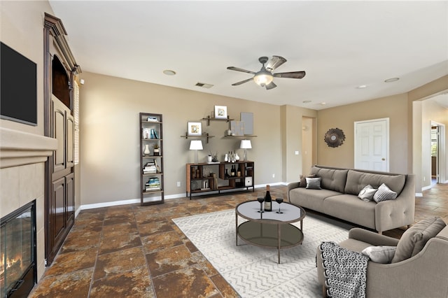 31139 Little Camille Way, Menifee, CA 92584 - living area featuring a tiled fireplace, a ceiling fan, stone tile flooring, and recessed lighting