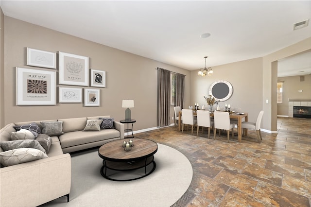 31139 Little Camille Way, Menifee, CA 92584 - living area with stone tile flooring, a chandelier, a fireplace, and healthy amount of natural light