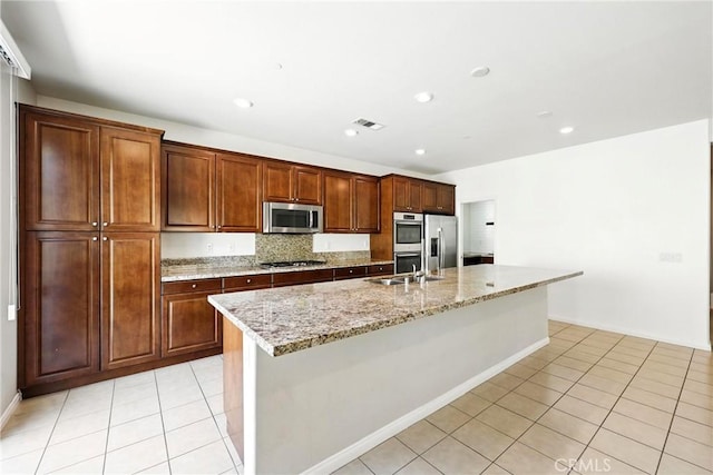 6212 Athena St, Chino, CA 91710 - kitchen with appliances with stainless steel finishes, light tile patterned flooring, an island with sink, light stone counters, and recessed lighting