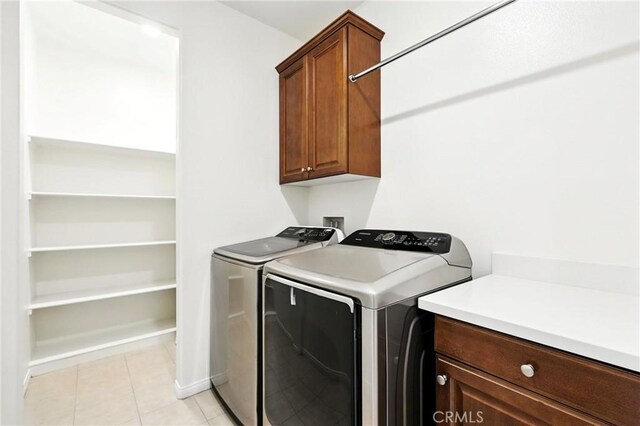 6212 Athena St, Chino, CA 91710 - laundry area featuring cabinet space, washing machine and dryer, and light tile patterned flooring