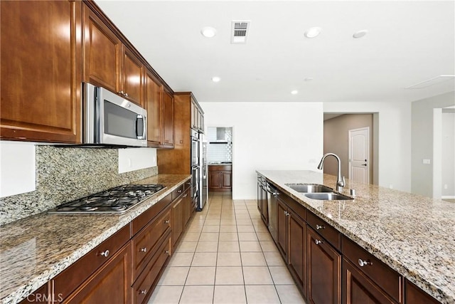 6212 Athena St, Chino, CA 91710 - kitchen with appliances with stainless steel finishes, backsplash, light stone countertops, light tile patterned floors, and recessed lighting