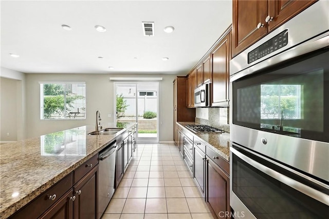 6212 Athena St, Chino, CA 91710 - kitchen featuring stainless steel appliances, decorative backsplash, light tile patterned flooring, recessed lighting, and light stone countertops