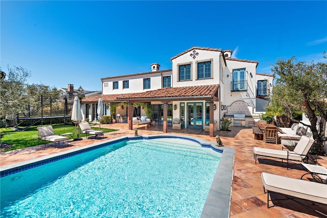 1 Overlook Dr, Ladera Ranch, CA 92694 - back of house with french doors, a patio area, stucco siding, a tiled roof, and an outdoor pool