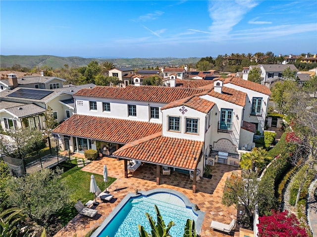 1 Overlook Dr, Ladera Ranch, CA 92694 - back of property with a tiled roof, a residential view, an outdoor pool, and stucco siding