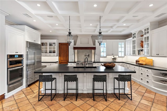 1 Overlook Dr, Ladera Ranch, CA 92694 - kitchen featuring appliances with stainless steel finishes, a warming drawer, dark countertops, custom range hood, and coffered ceiling