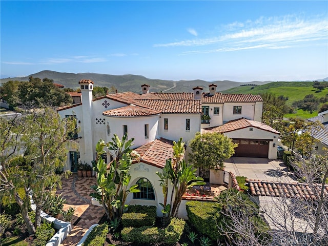 1 Overlook Dr, Ladera Ranch, CA 92694 - mediterranean / spanish-style house featuring stucco siding, a mountain view, a tile roof, driveway, and a chimney