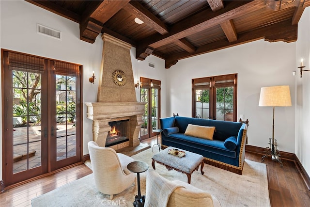 1 Overlook Dr, Ladera Ranch, CA 92694 - living area featuring a wooden ceiling with exposed beams, french doors, hardwood / wood-style floors, healthy amount of natural light, and a large fireplace