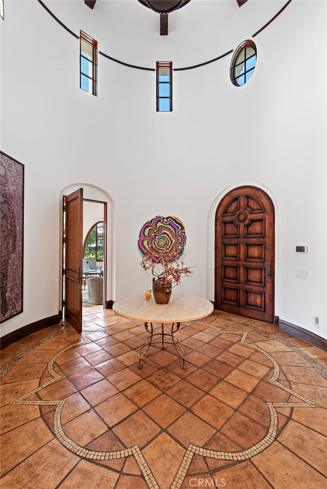 1 Overlook Dr, Ladera Ranch, CA 92694 - foyer with arched walkways, a towering ceiling, inlaid floor details, and healthy amount of natural light