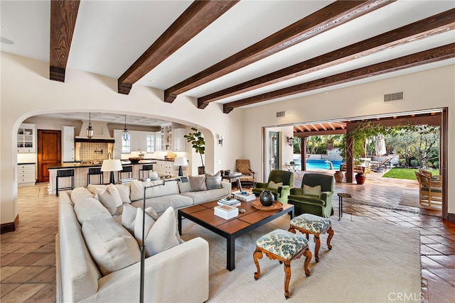1 Overlook Dr, Ladera Ranch, CA 92694 - living area featuring arched walkways, plenty of natural light, beamed ceiling, and light tile patterned floors