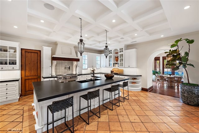 1 Overlook Dr, Ladera Ranch, CA 92694 - kitchen with custom range hood, dark countertops, arched walkways, a breakfast bar area, and range with two ovens