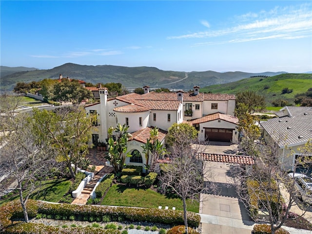 1 Overlook Dr, Ladera Ranch, CA 92694 - view of front of home featuring a chimney, stucco siding, a tiled roof, and a mountain view