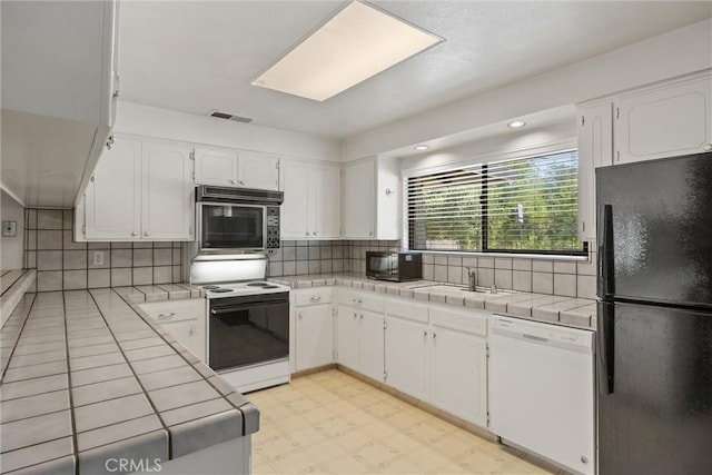 835 Madrone Ave, Chico, CA 95926 - kitchen with black appliances, tile countertops, and white cabinets