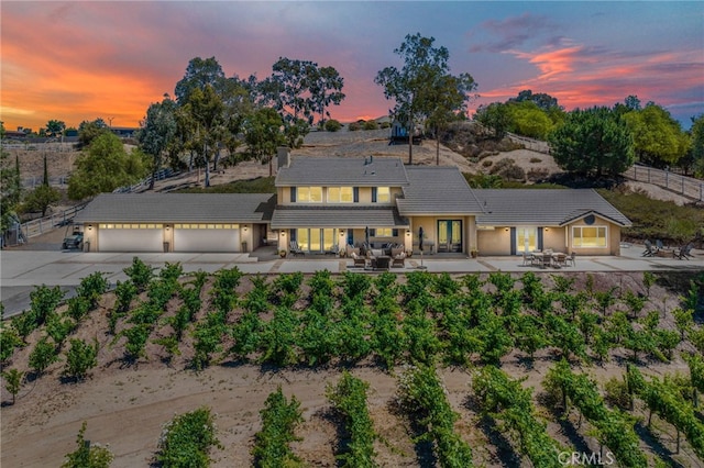 33612 Vino Way, Temecula, CA 92591 - view of front facade featuring concrete driveway, french doors, a patio area, an attached garage, and a tile roof