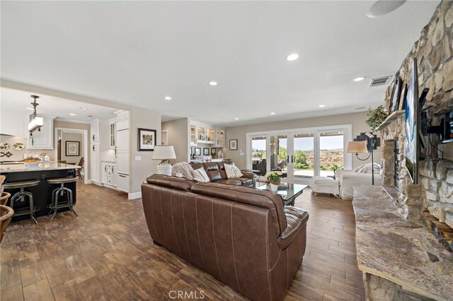 33612 Vino Way, Temecula, CA 92591 - living area featuring dark wood-style floors, a stone fireplace, and recessed lighting