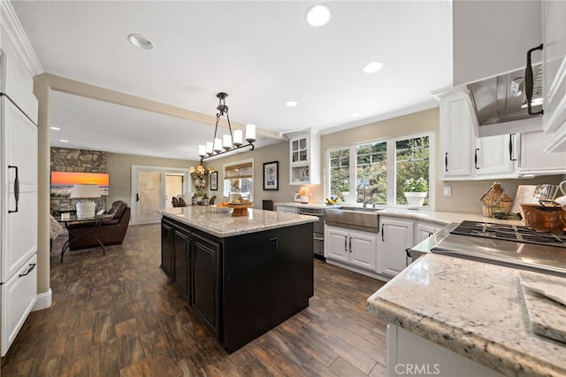 33612 Vino Way, Temecula, CA 92591 - kitchen featuring dark wood-style floors, open floor plan, crown molding, white cabinetry, and a kitchen island