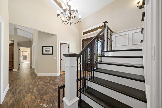 33612 Vino Way, Temecula, CA 92591 - staircase featuring wood finished floors, a chandelier, and a towering ceiling