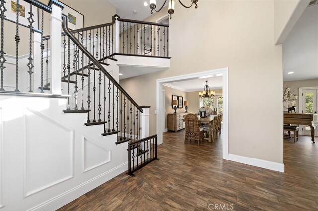 33612 Vino Way, Temecula, CA 92591 - stairway featuring a chandelier, a towering ceiling, and wood finished floors