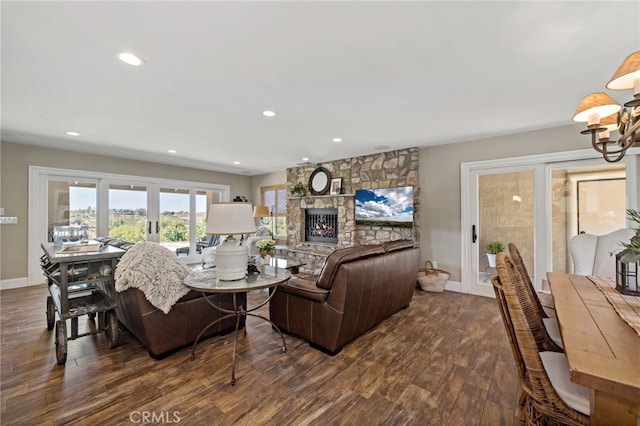 33612 Vino Way, Temecula, CA 92591 - living room featuring dark wood-style floors, a stone fireplace, recessed lighting, and a chandelier