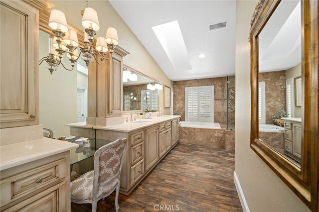 33612 Vino Way, Temecula, CA 92591 - full bath with a bath, vanity, wood finished floors, a skylight, and a chandelier