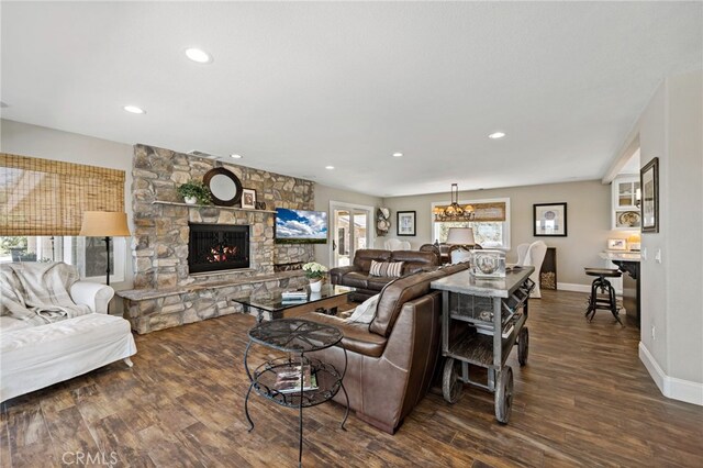 33612 Vino Way, Temecula, CA 92591 - living area with a stone fireplace, wood finished floors, recessed lighting, and a chandelier
