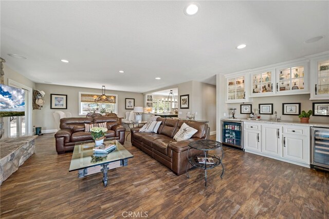 33612 Vino Way, Temecula, CA 92591 - living room featuring wine cooler, wet bar, a chandelier, dark wood-style flooring, and recessed lighting