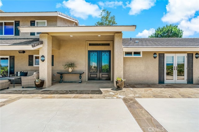 33612 Vino Way, Temecula, CA 92591 - view of exterior entry with french doors, a patio area, stucco siding, and outdoor lounge area