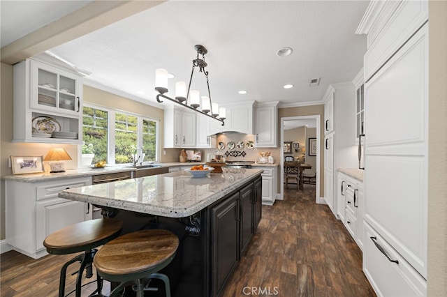 33612 Vino Way, Temecula, CA 92591 - kitchen with a center island, ornamental molding, white cabinetry, dark wood-style flooring, and recessed lighting