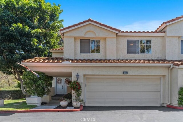 239 Via Presa, San Clemente, CA 92672 - view of front facade with a tiled roof, a garage, and stucco siding