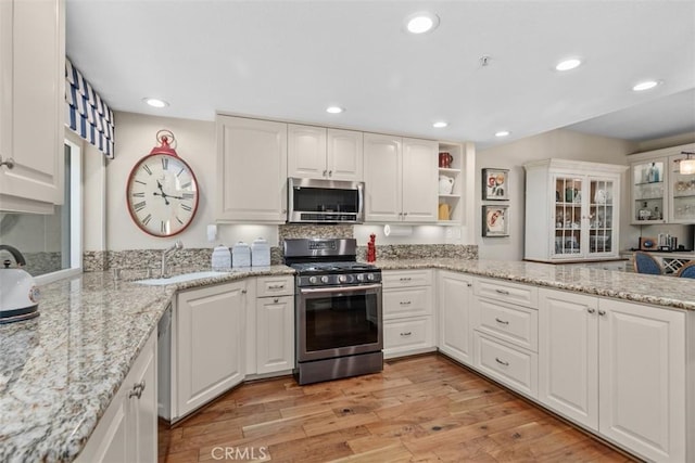 239 Via Presa, San Clemente, CA 92672 - kitchen featuring stainless steel appliances, white cabinetry, recessed lighting, light wood finished floors, and light stone countertops