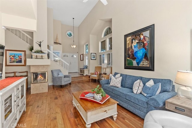 239 Via Presa, San Clemente, CA 92672 - living room featuring stairway, high vaulted ceiling, light wood-type flooring, a multi sided fireplace, and ceiling fan