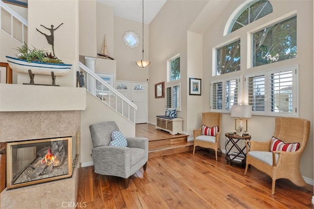 239 Via Presa, San Clemente, CA 92672 - living area with a high ceiling, stairway, hardwood / wood-style floors, healthy amount of natural light, and a glass covered fireplace