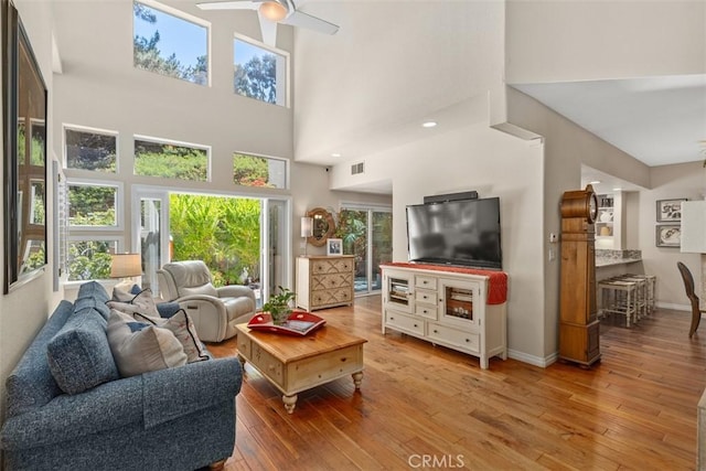 239 Via Presa, San Clemente, CA 92672 - living area featuring ceiling fan, a high ceiling, plenty of natural light, and light wood-style flooring