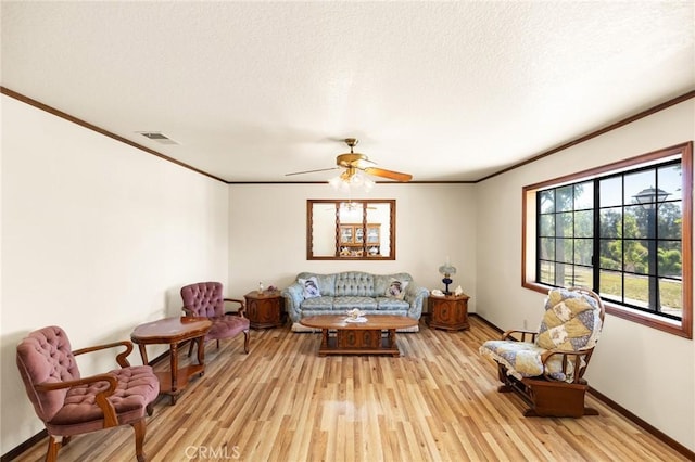 41050 Mesa Robles Cir, Temecula, CA 92592 - living area featuring crown molding, light wood-style flooring, ceiling fan, and a textured ceiling