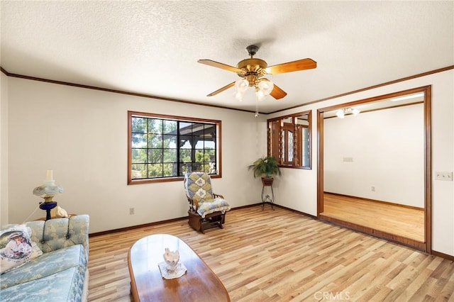 41050 Mesa Robles Cir, Temecula, CA 92592 - living area featuring light wood-type flooring, a ceiling fan, crown molding, and a textured ceiling