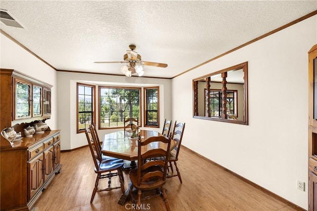 41050 Mesa Robles Cir, Temecula, CA 92592 - dining space featuring crown molding, light wood-style floors, ceiling fan, and a textured ceiling