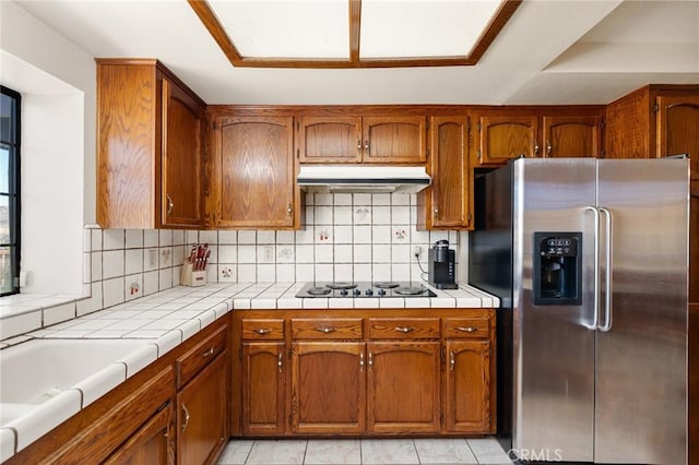 41050 Mesa Robles Cir, Temecula, CA 92592 - kitchen featuring stainless steel fridge with ice dispenser, under cabinet range hood, black stovetop, and brown cabinetry