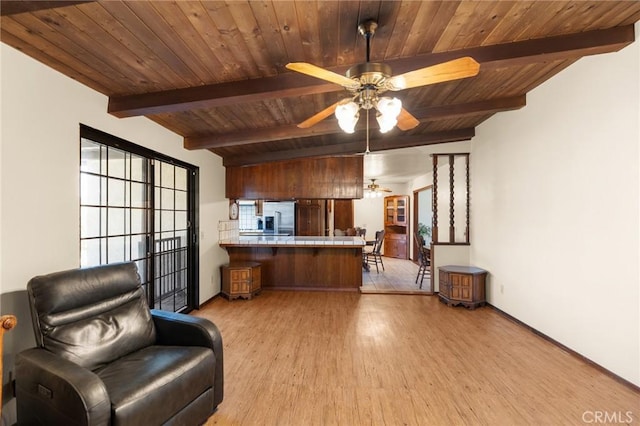 41050 Mesa Robles Cir, Temecula, CA 92592 - kitchen with ceiling fan, wood finished floors, stainless steel refrigerator with ice dispenser, a wood ceiling with exposed beams, and a peninsula
