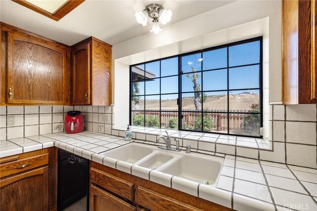 41050 Mesa Robles Cir, Temecula, CA 92592 - kitchen featuring dishwasher, backsplash, and brown cabinetry