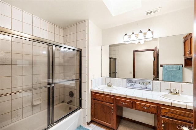 41050 Mesa Robles Cir, Temecula, CA 92592 - full bathroom with double vanity, shower / bath combination with glass door, and tile patterned floors