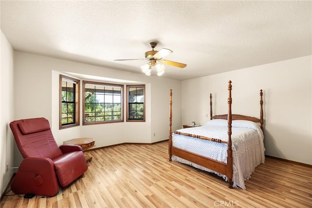 41050 Mesa Robles Cir, Temecula, CA 92592 - bedroom featuring light wood-type flooring, a textured ceiling, and a ceiling fan
