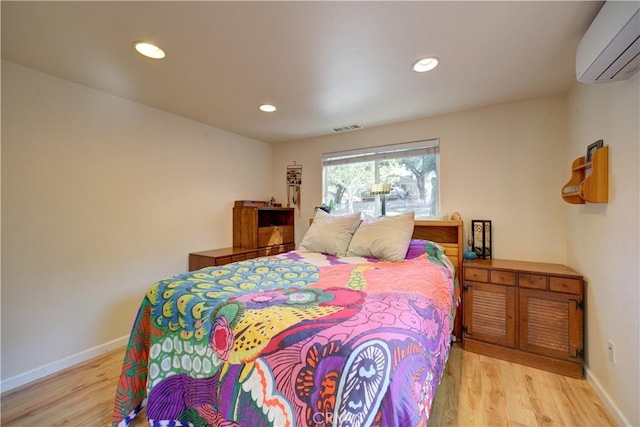 4887 Arizona Ave, Atascadero, CA 93422 - bedroom featuring a wall mounted AC, light wood-type flooring, and recessed lighting