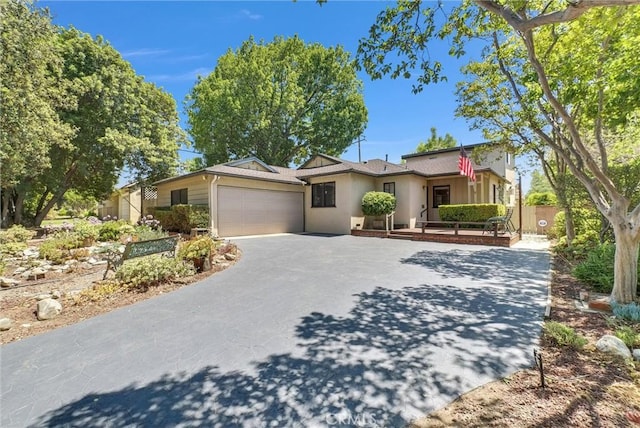506 Geneva Ave, Claremont, CA 91711 - ranch-style home with an attached garage, asphalt driveway, and stucco siding