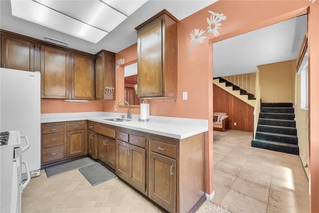 506 Geneva Ave, Claremont, CA 91711 - kitchen with light countertops, white appliances, and wooden walls