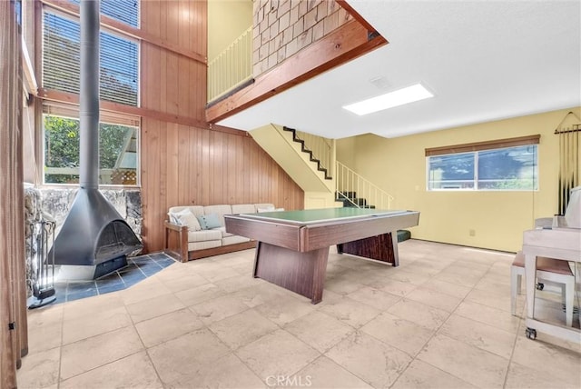 506 Geneva Ave, Claremont, CA 91711 - game room with wood walls, a towering ceiling, a wood stove, billiards, and tile patterned floors