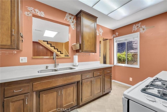506 Geneva Ave, Claremont, CA 91711 - kitchen with gas range gas stove, light countertops, brown cabinets, and light floors