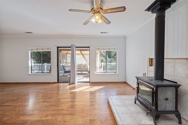 50128 Deer Meadow Way, Oakhurst, CA 93644 - unfurnished living room with a wood stove, crown molding, light wood-type flooring, and a ceiling fan