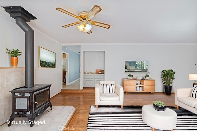 50128 Deer Meadow Way, Oakhurst, CA 93644 - living area with a wood stove, crown molding, wood finished floors, and ceiling fan