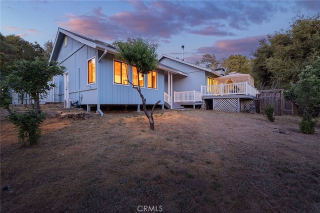 50128 Deer Meadow Way, Oakhurst, CA 93644 - back of property at dusk featuring a wooden deck