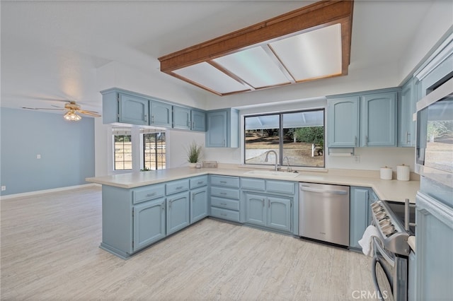 50128 Deer Meadow Way, Oakhurst, CA 93644 - kitchen with stainless steel appliances, blue cabinetry, and a peninsula